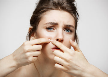 A woman popping acne