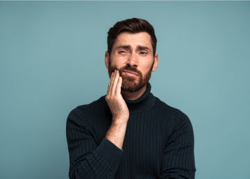 A man holding his face in pain