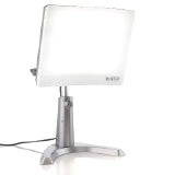 A silver therapy lamp with a large face