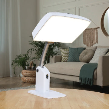 The Day-Light Sky light therapy lamp sitting on a table in a living room.