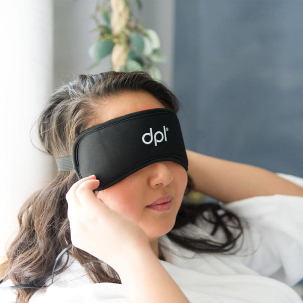 A woman with the DPL Red Light Therapy Eye Mask over her eyes