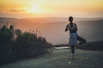 A woman on a mountain doing yoga