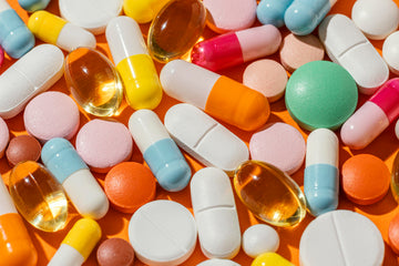 Various pills on an orange background