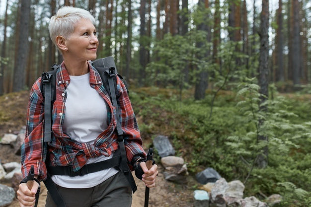 An elderly woman hiking in nature