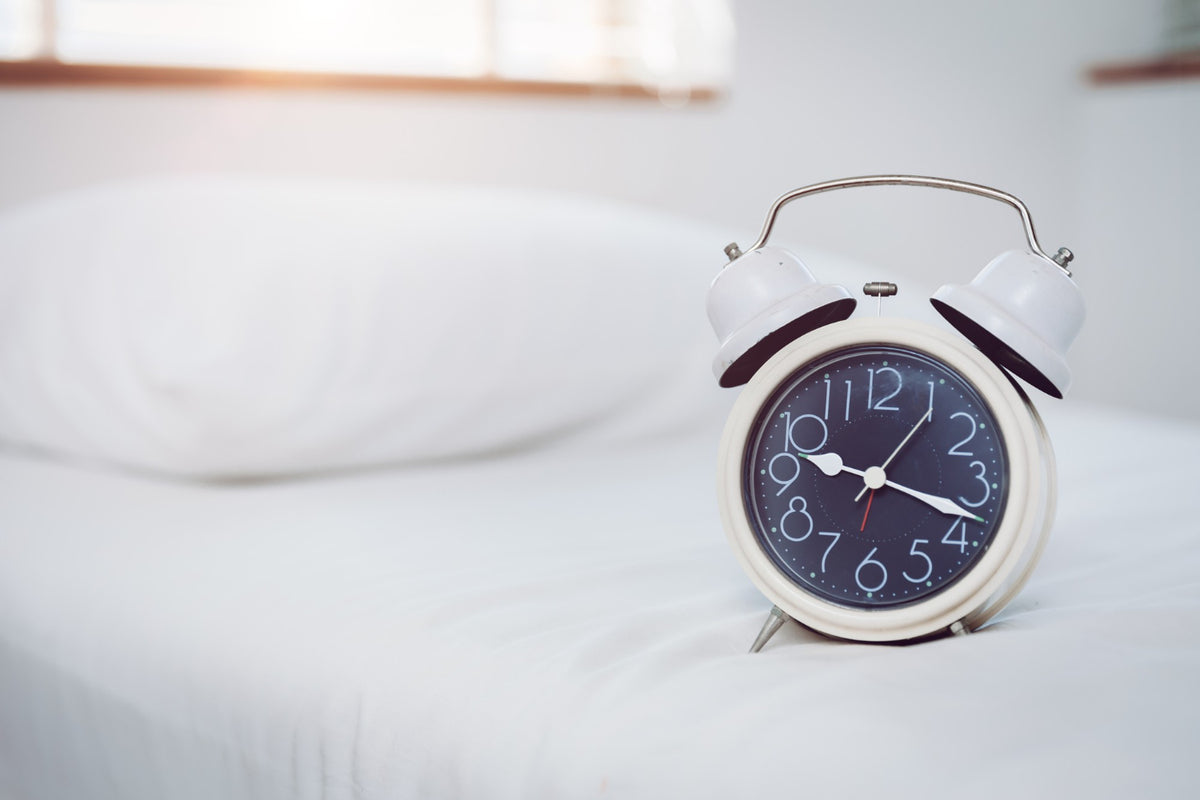 A clock on a bed