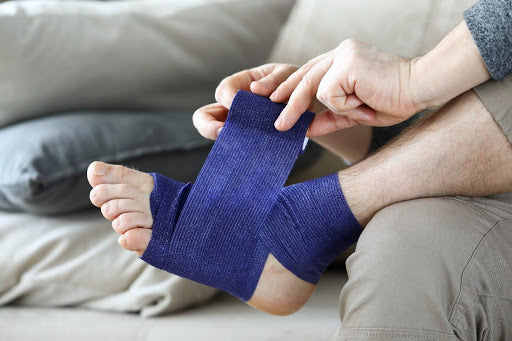 A foot being wrapped in a bandage