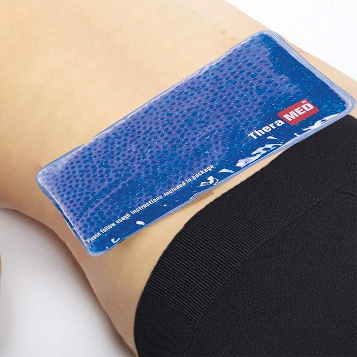 The TheraMed cold pack over a person’s lower back