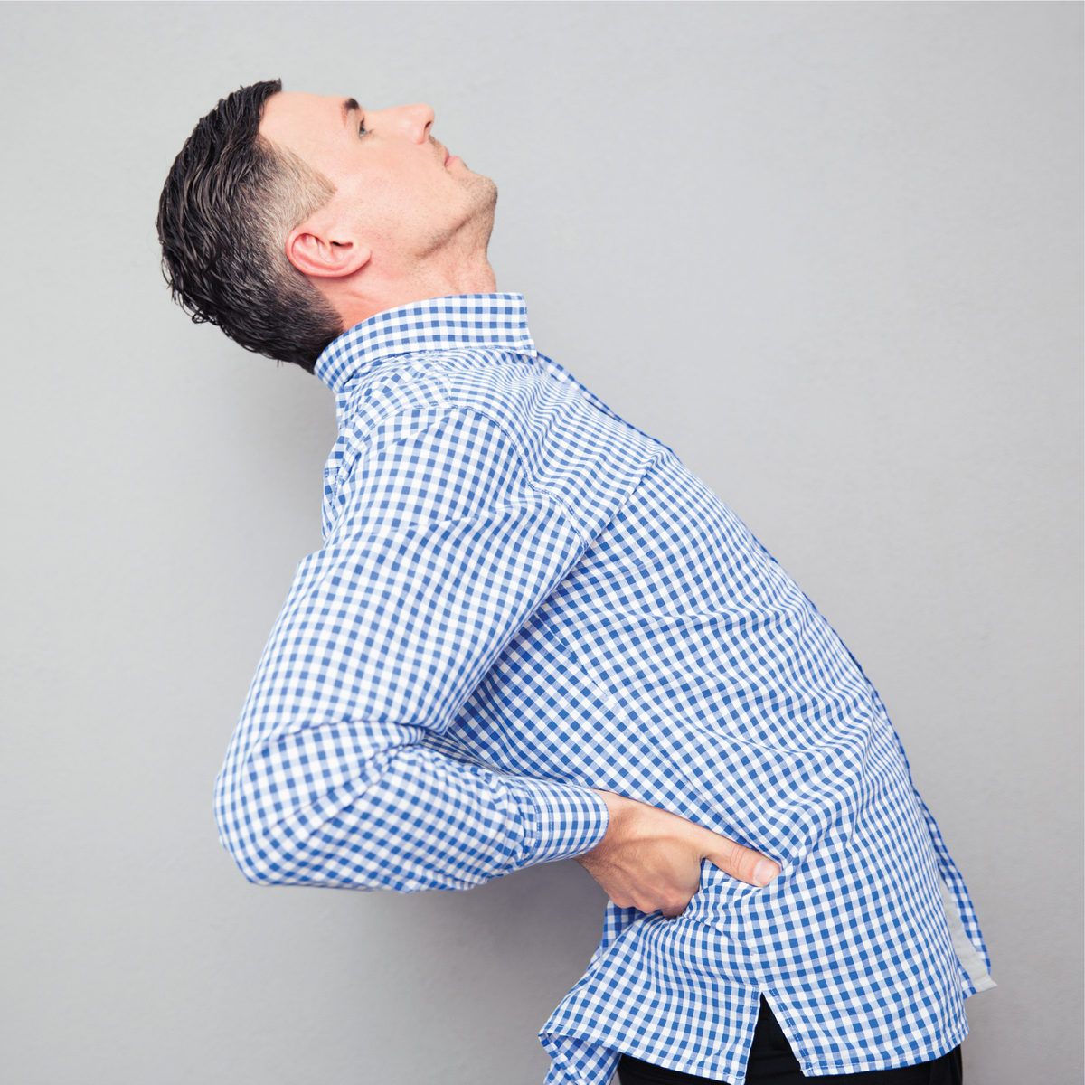 A man holding his lower back in pain
