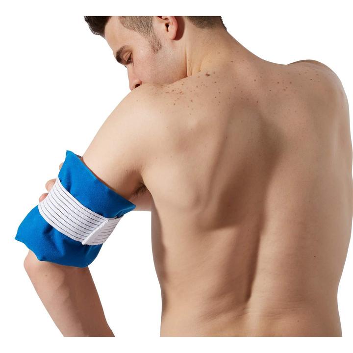 The TheraMed Cold Universal Pad on a man’s upper arm over a white background