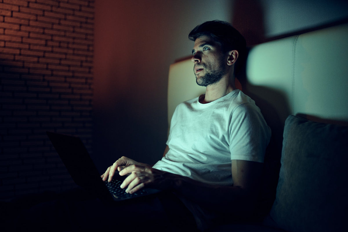 A man on a computer at night
