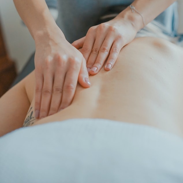 Close-up of hands massing a person’s back