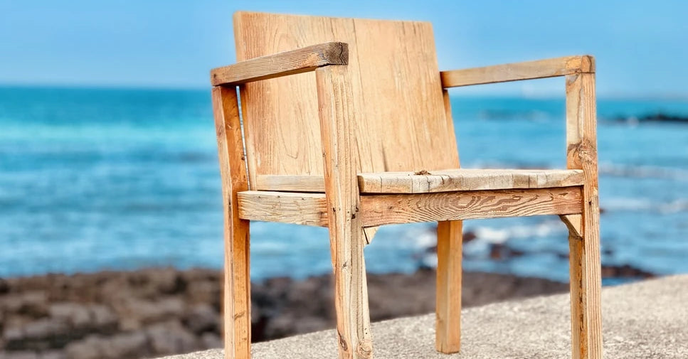 A wooden chair on a beach