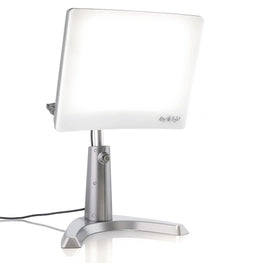 A silver therapy lamp with a large face