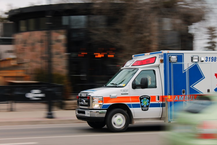 A blurred image of an ambulance speeding by