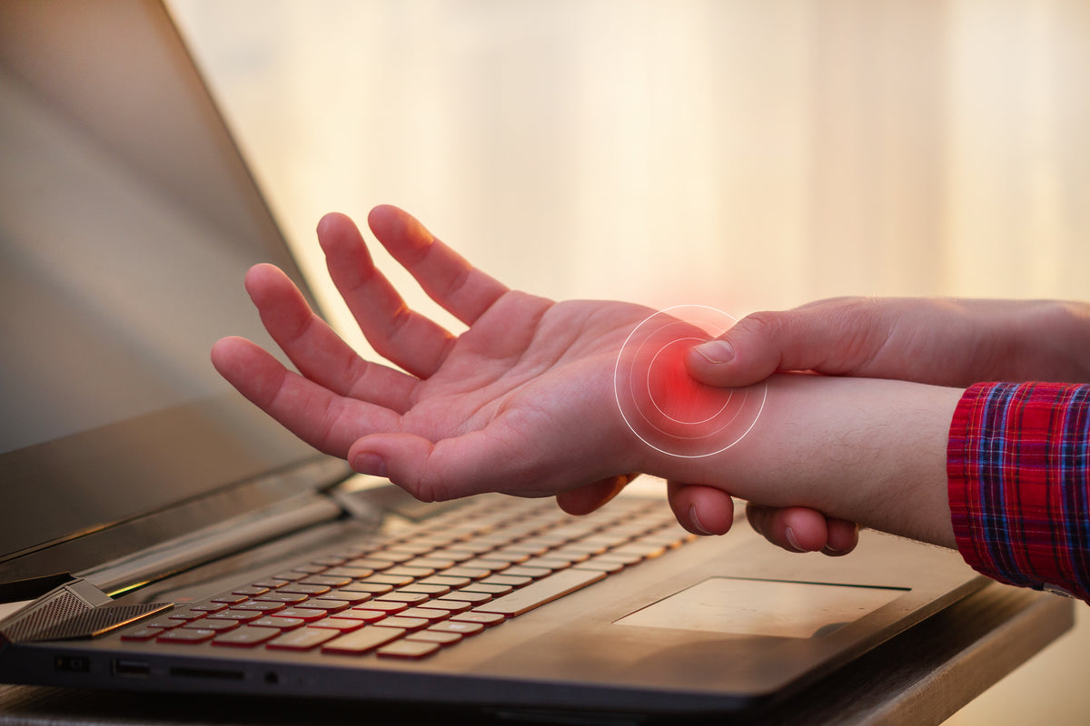 A person holding their wrist in pain