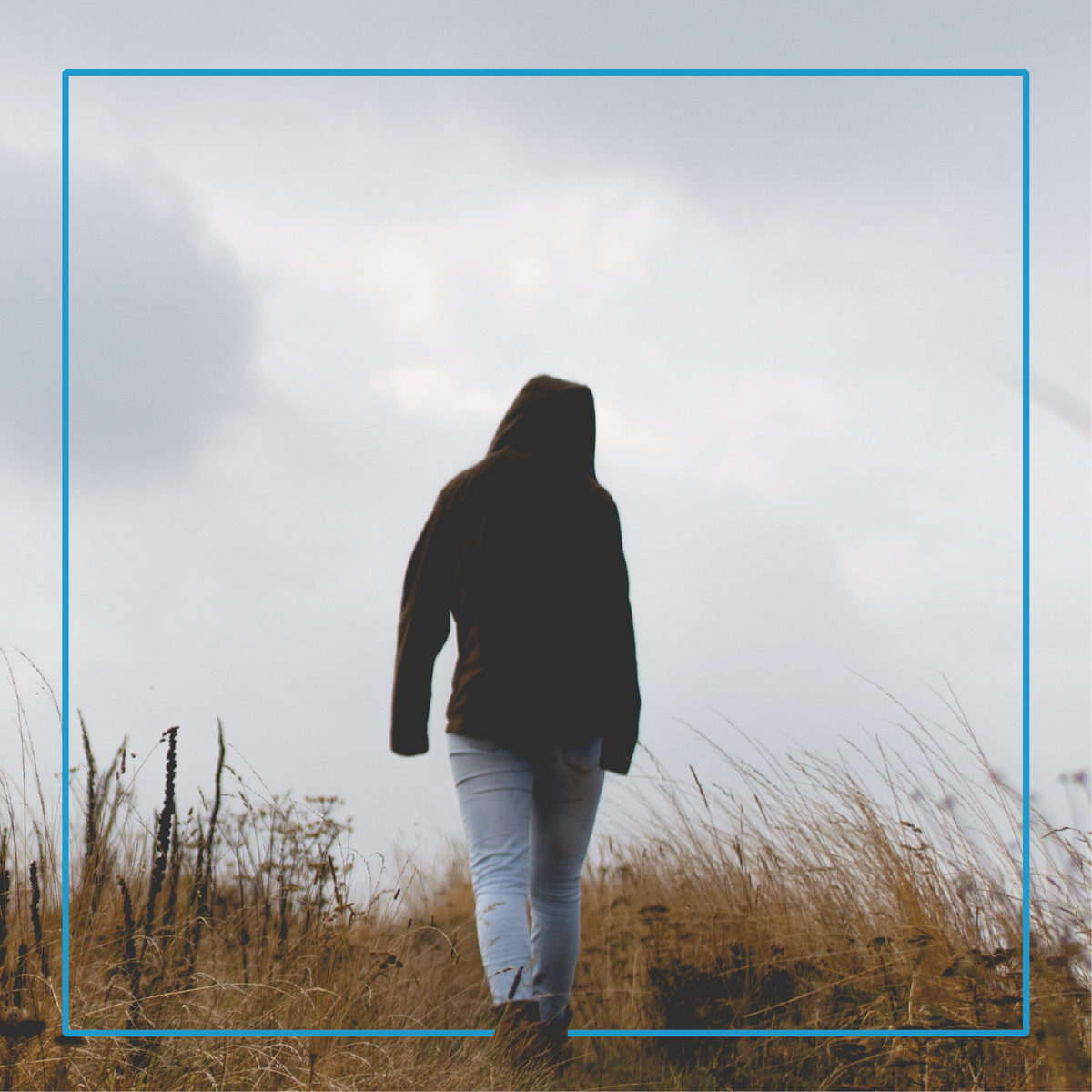 A woman walking outside in cloudy weather