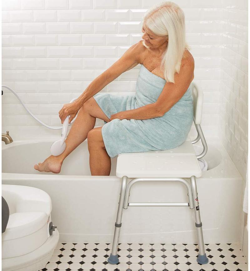 An elderly woman using a transfer bench in a tub