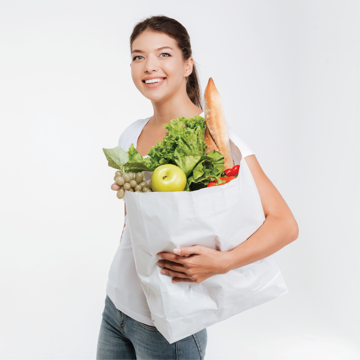 A woman holding a bag of groceries