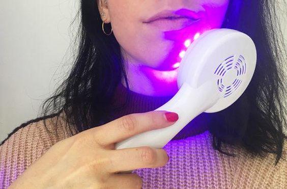 Woman using the reVive Light Therapy® Clinical over her chin