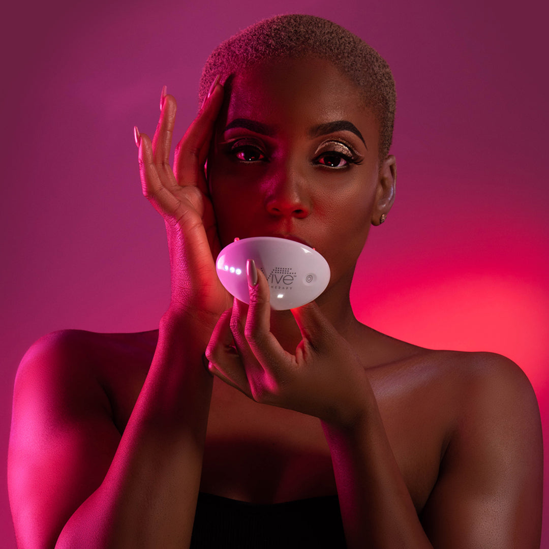 A woman with the reVive Lip Care Light Therapy System over her mouth