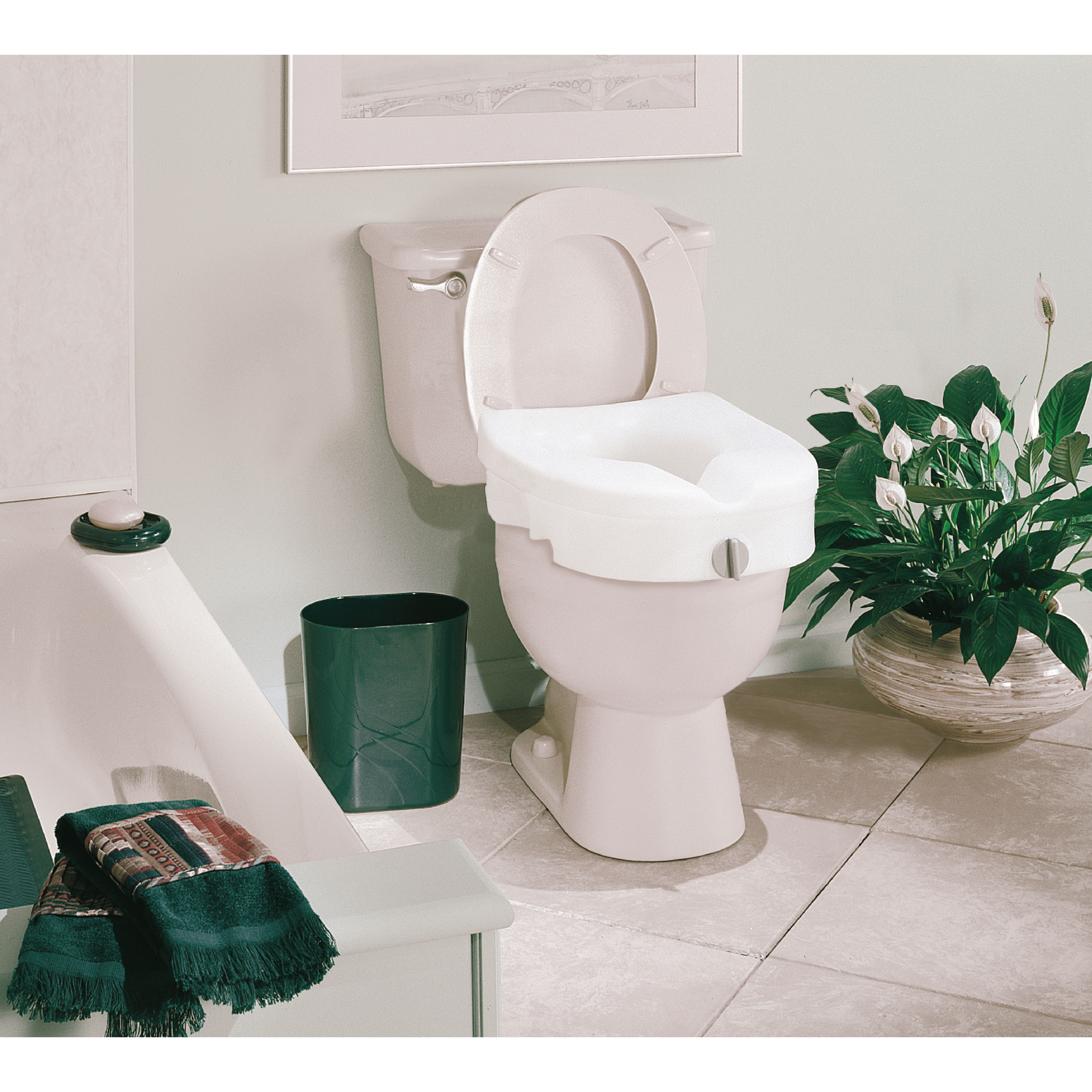 A raised toilet seat in a bathroom