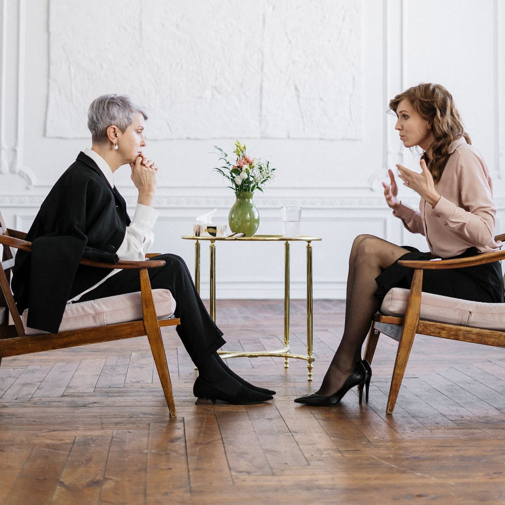 A therapist talking to a patient