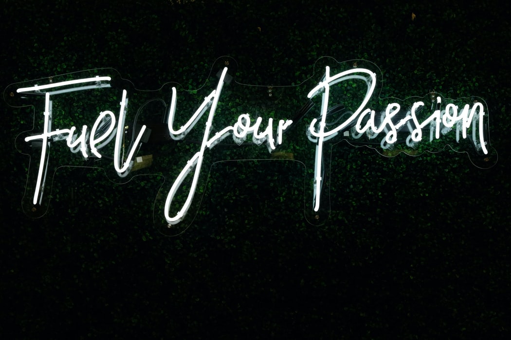 A illuminated sign that says “fuel your passion”