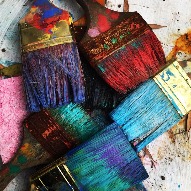 Various paint brushes that have been stained by pain