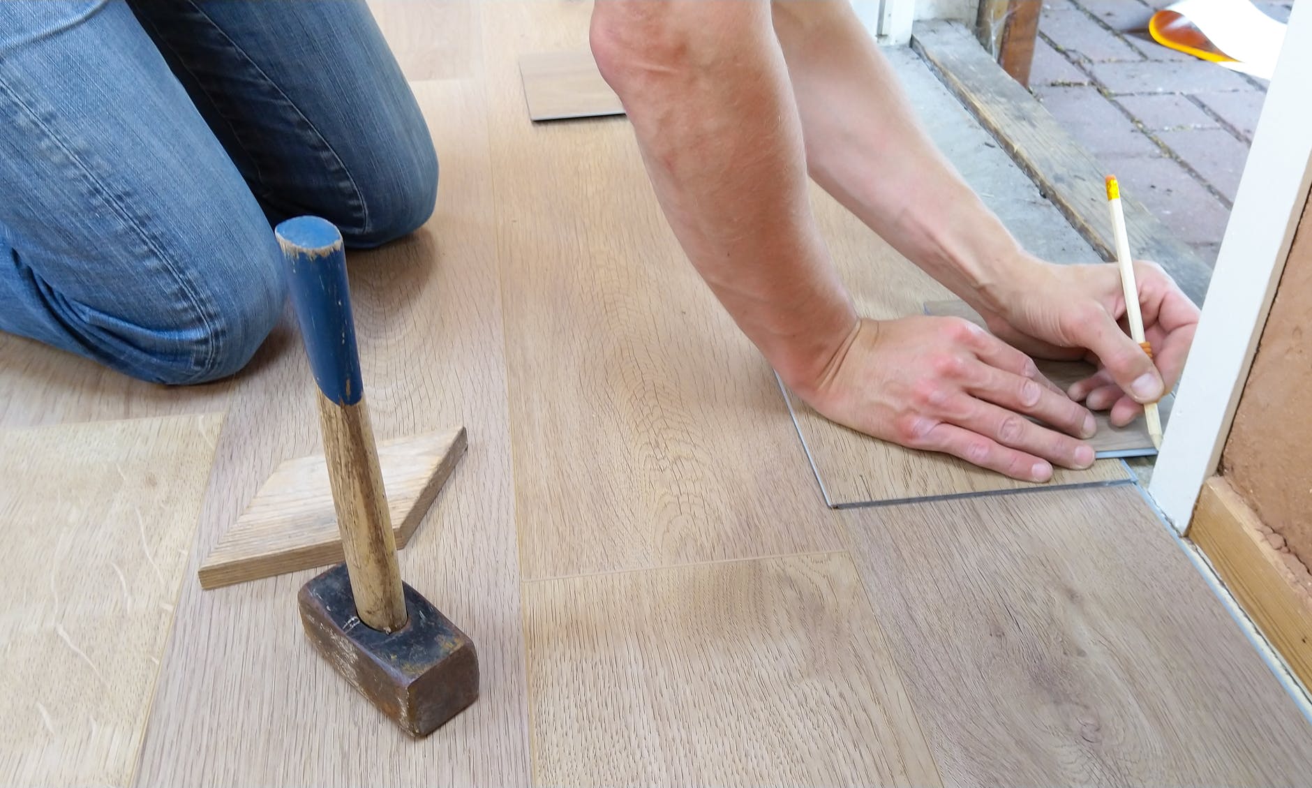 A man placing flooring