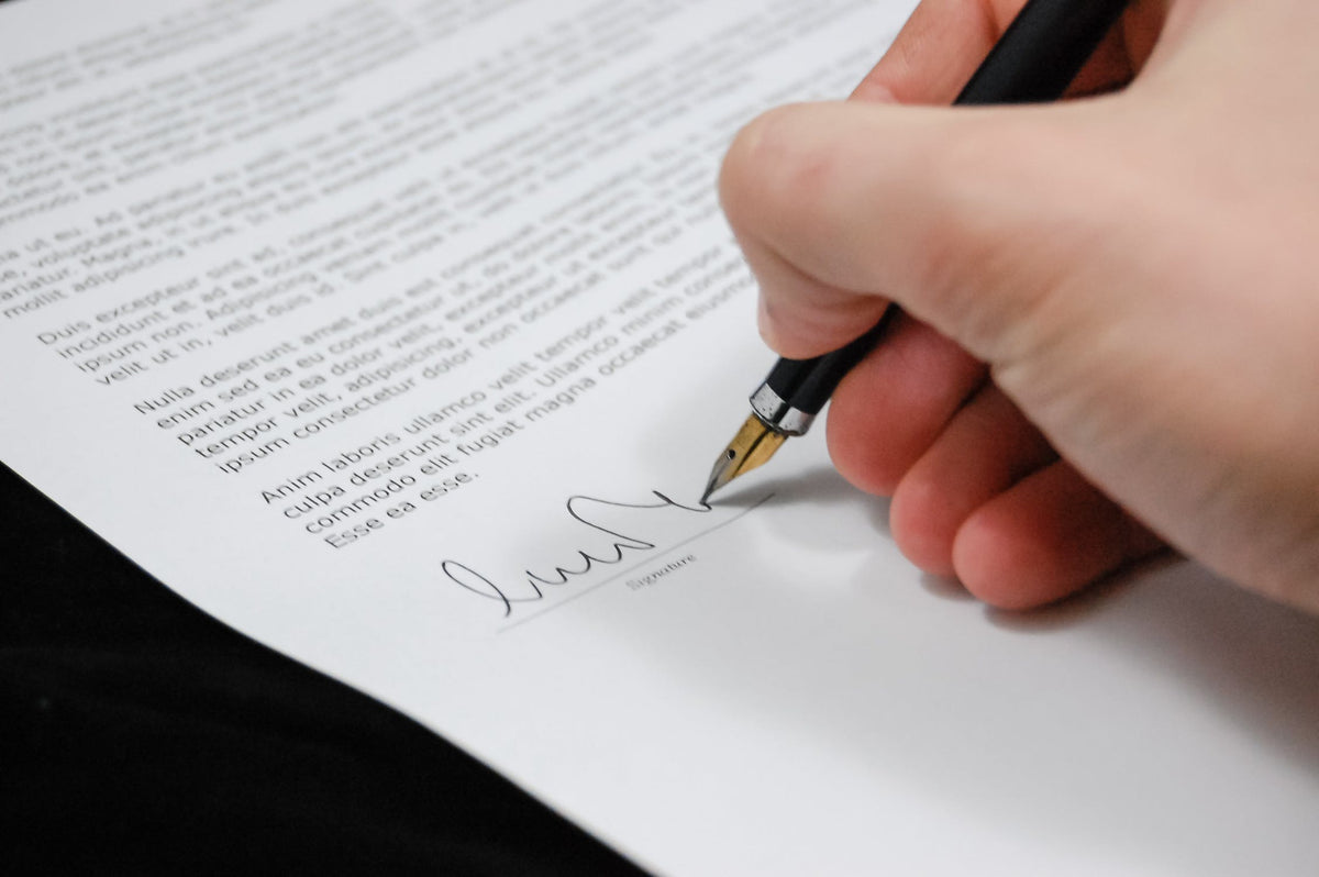 Close up of someone signing a contract