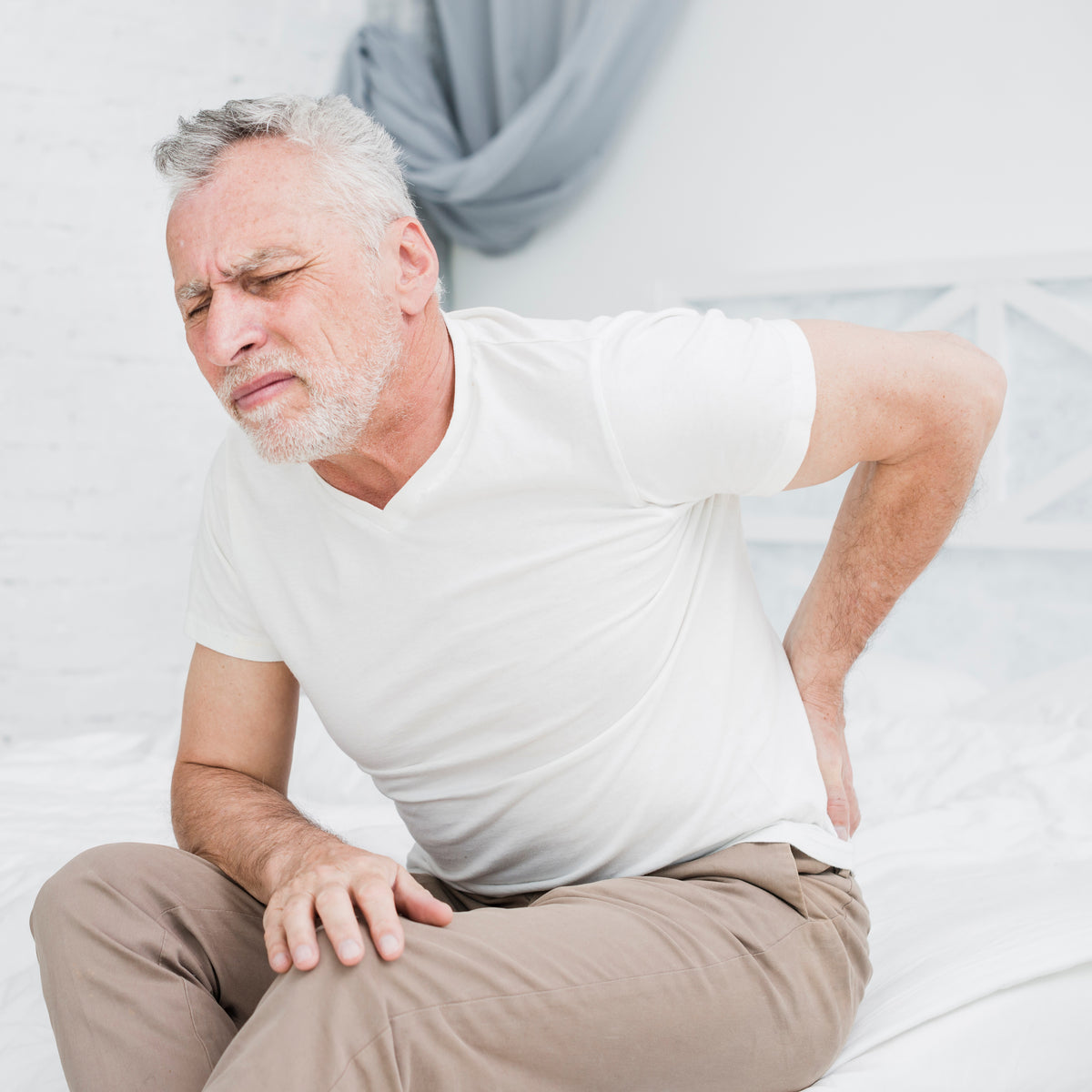 A man in bed with back pain
