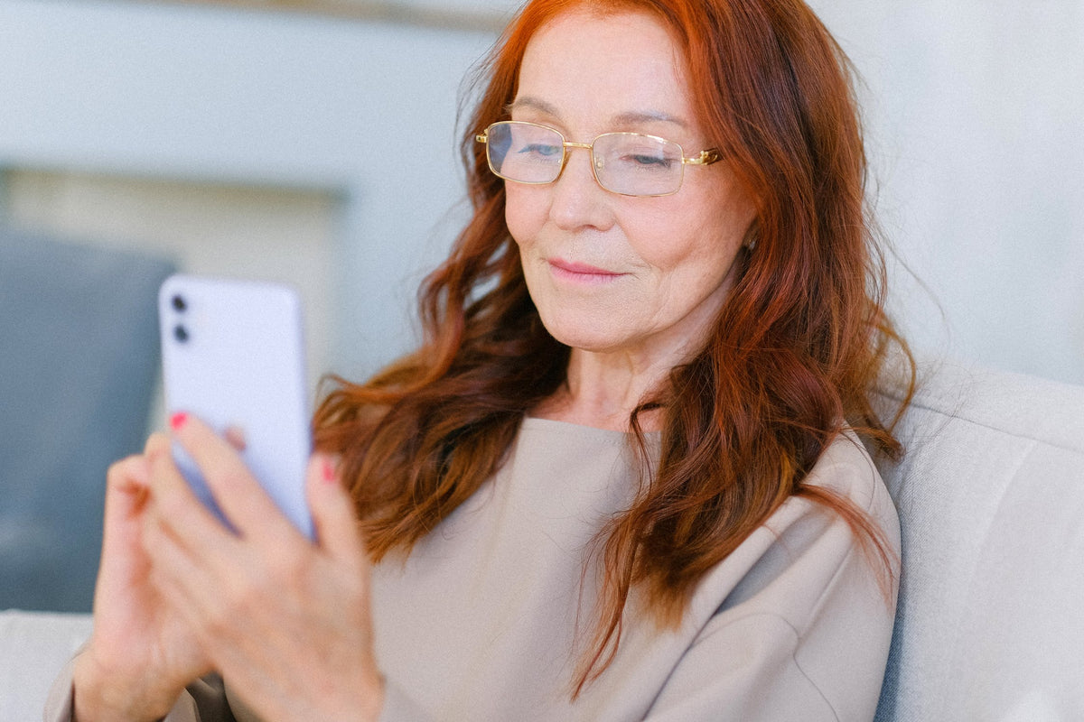 An elderly woman using her cell phone