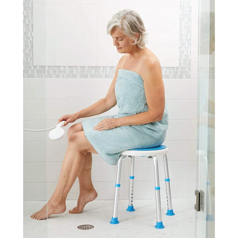 A woman showering with a silver and blue shower stool