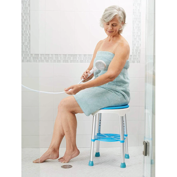 A woman sitting on the Carex EZ Swivel Stool in a shower