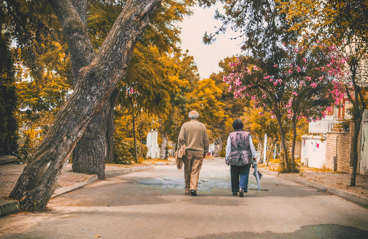 An elderly couple walking on a street
