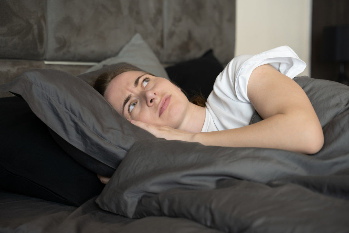 A woman stressed while in bed