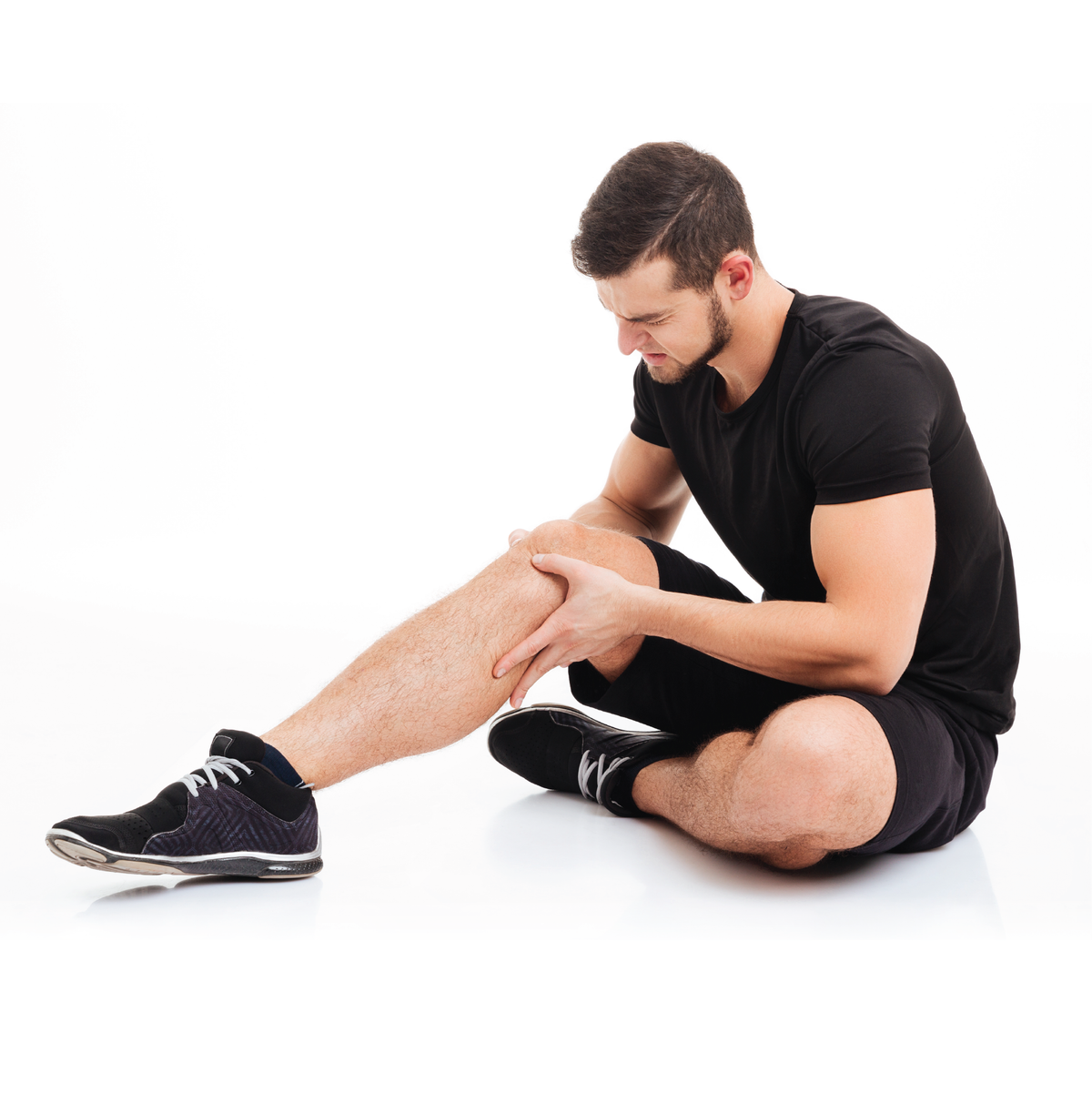 A man sitting down with knee pain