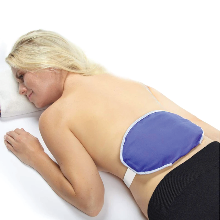 A woman with the ThermiPaq relief wrap over lower back on a white background