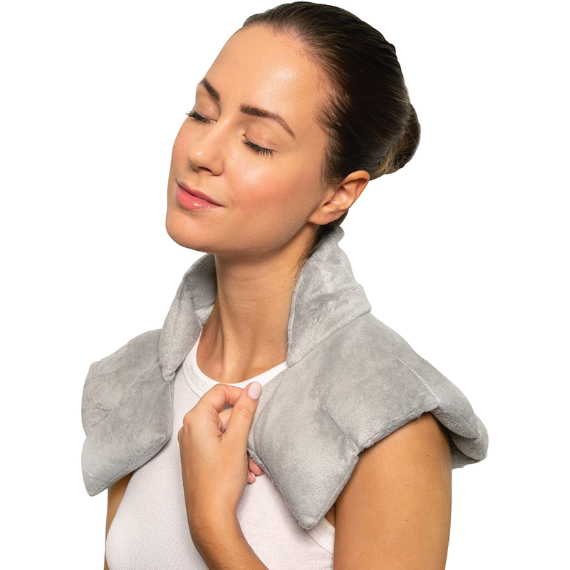 A woman with the Bed Buddy wrap over her shoulders on a white background 