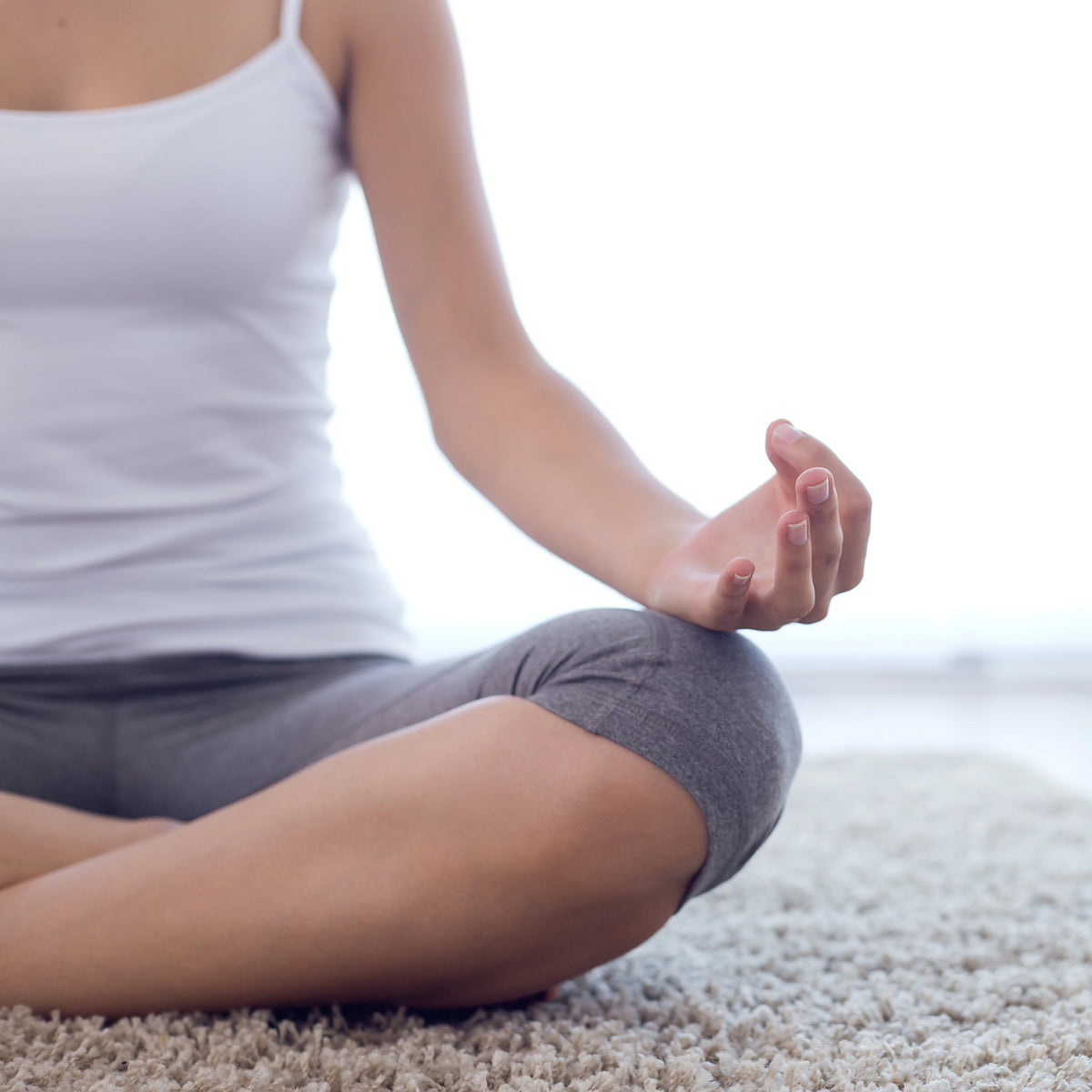 A close up of a woman meditating