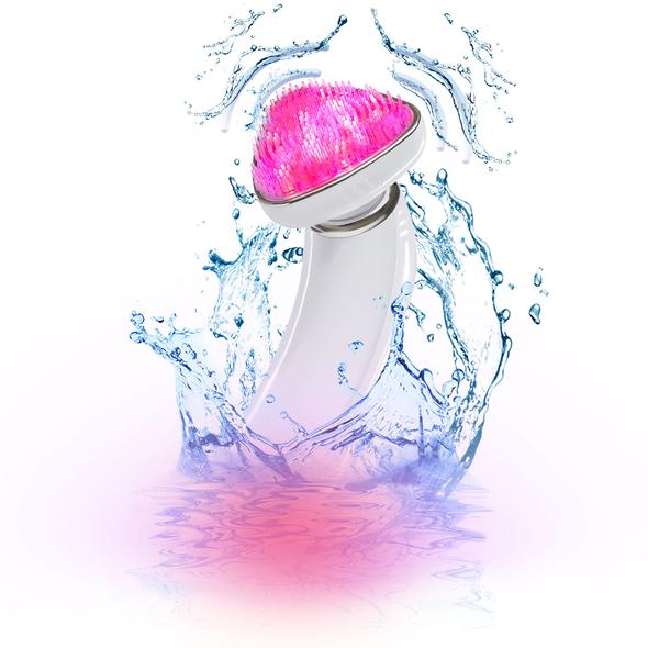 The ReVive Light Sonique Clinical surrounded by splashing water on a white background 