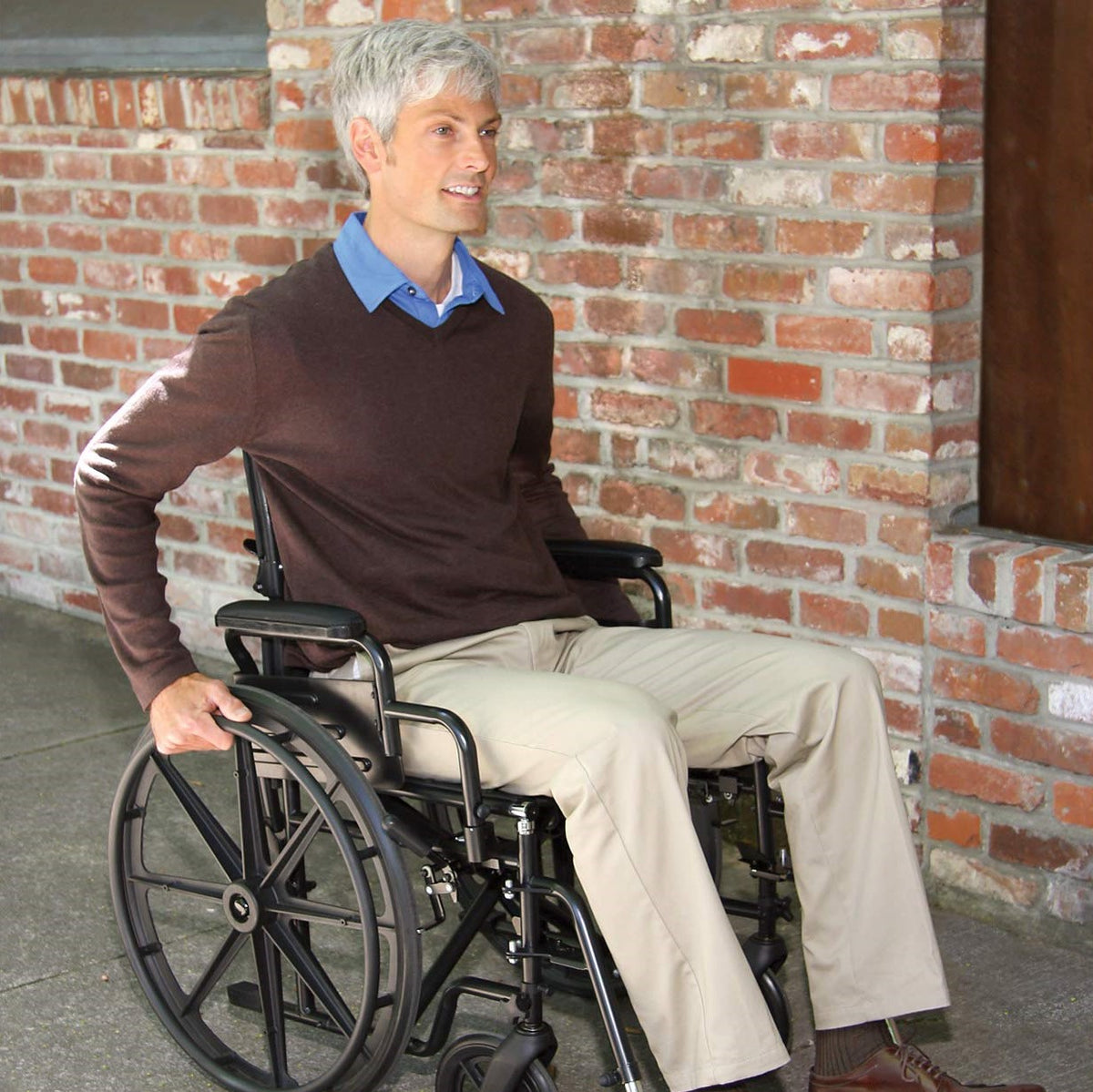 A man pushing himself in a Carex wheelchair