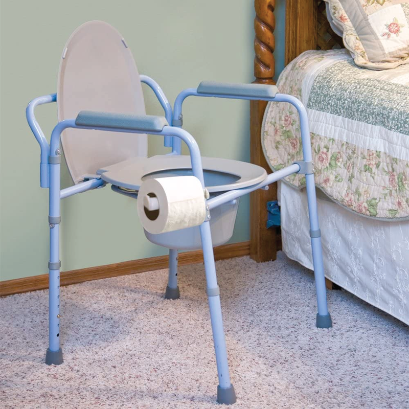 A blue commode next to a bed