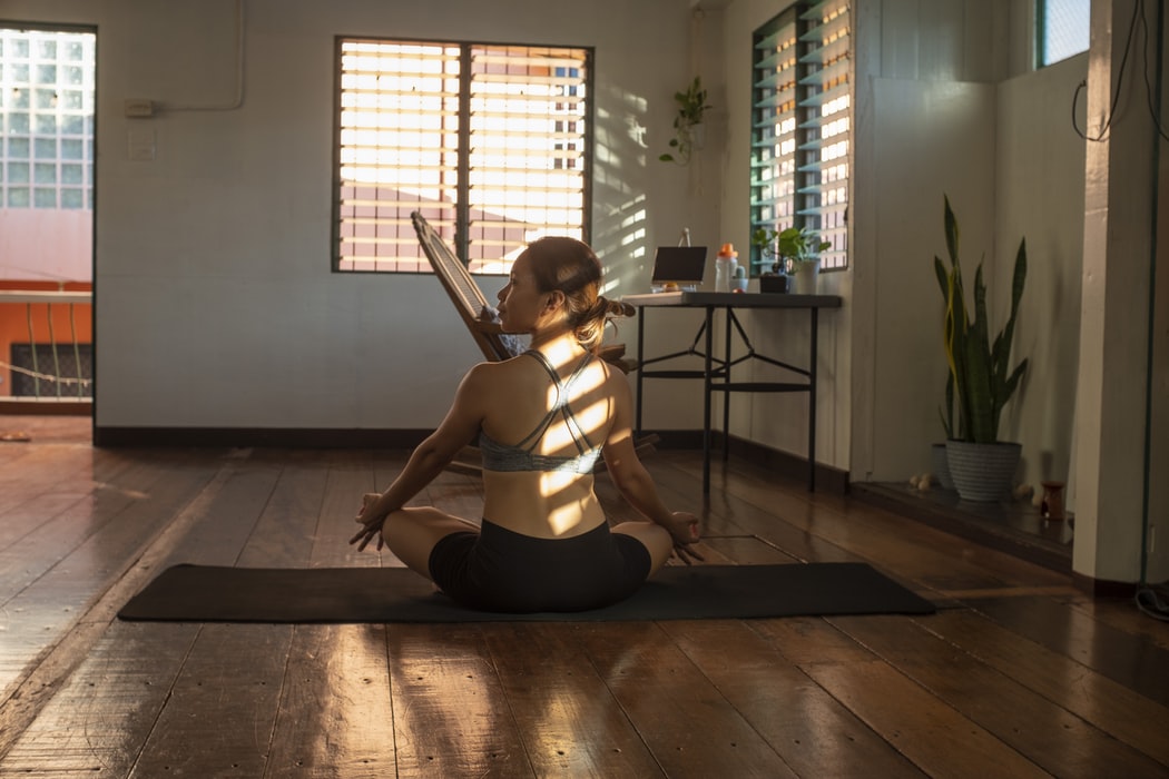 A woman doing yoga on a yoga mat