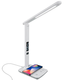 A white therapy lamp with a long face and cell phone charging on it