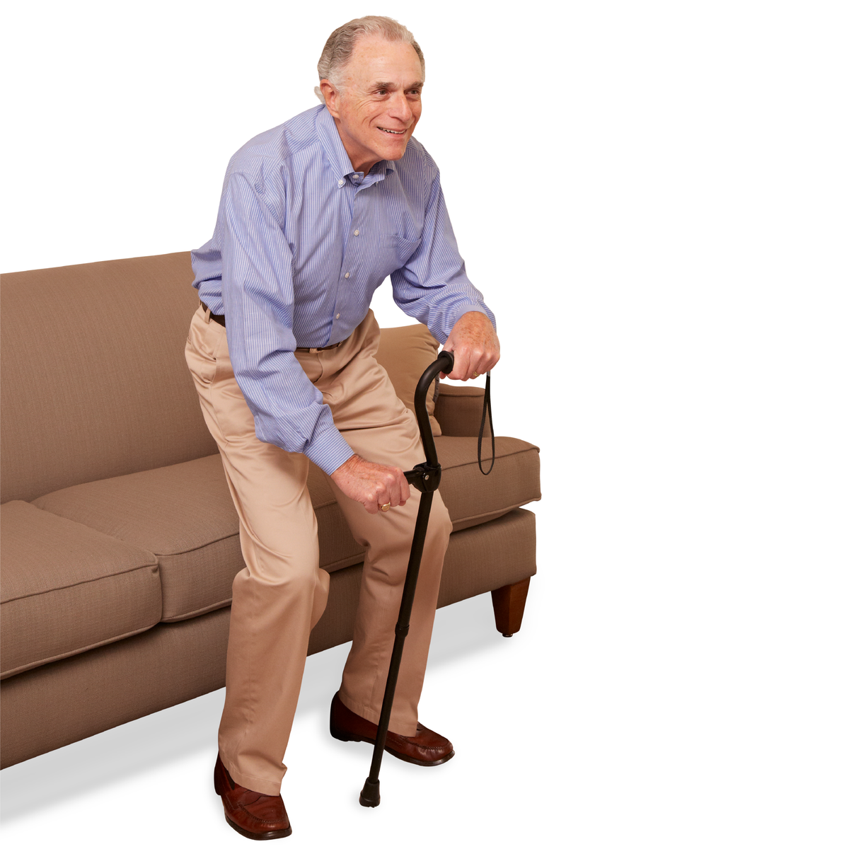 An elderly man standing up using the Carex Uplift Cane