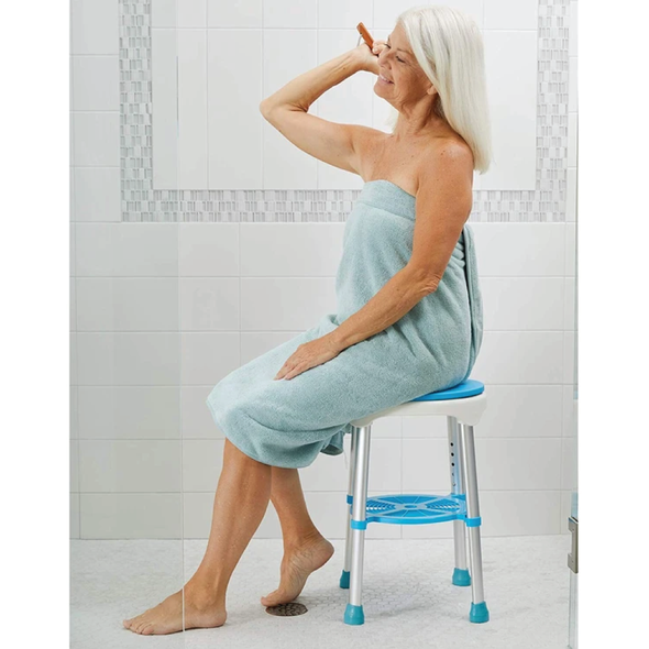 A woman sitting on the Carex EZ Swivel Stool in a shower