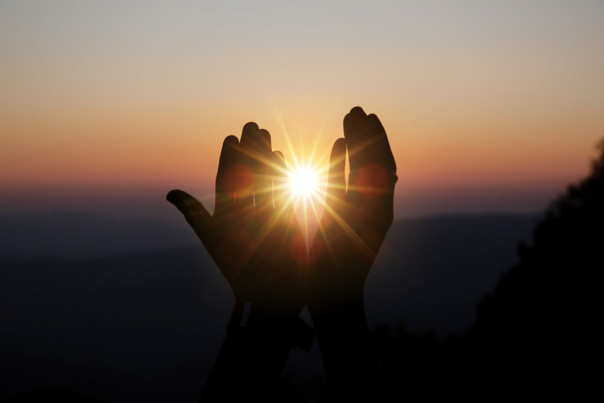 Hands in front of the sun