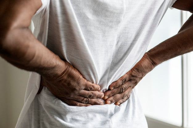 A man holding his lower back in pain