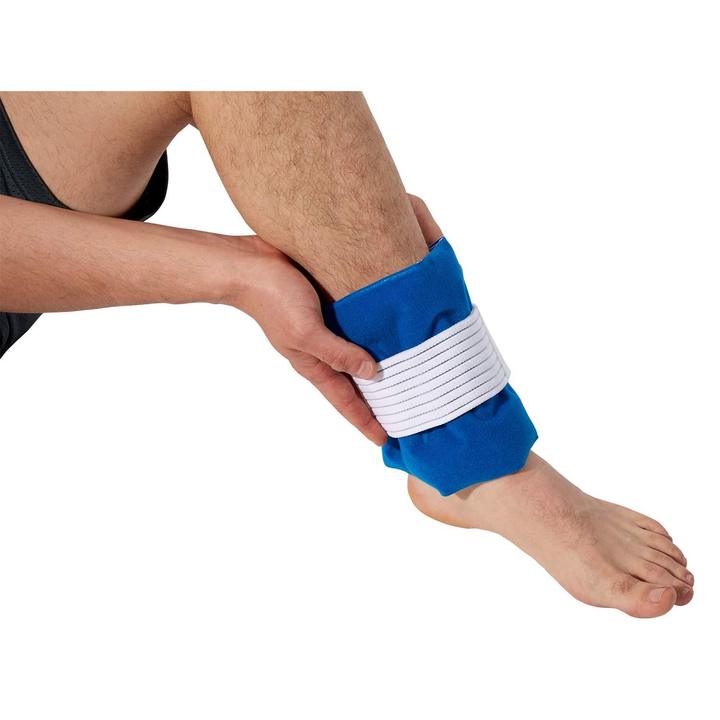 The TheraMed Cold Universal Pad on a mans ankle over a white background